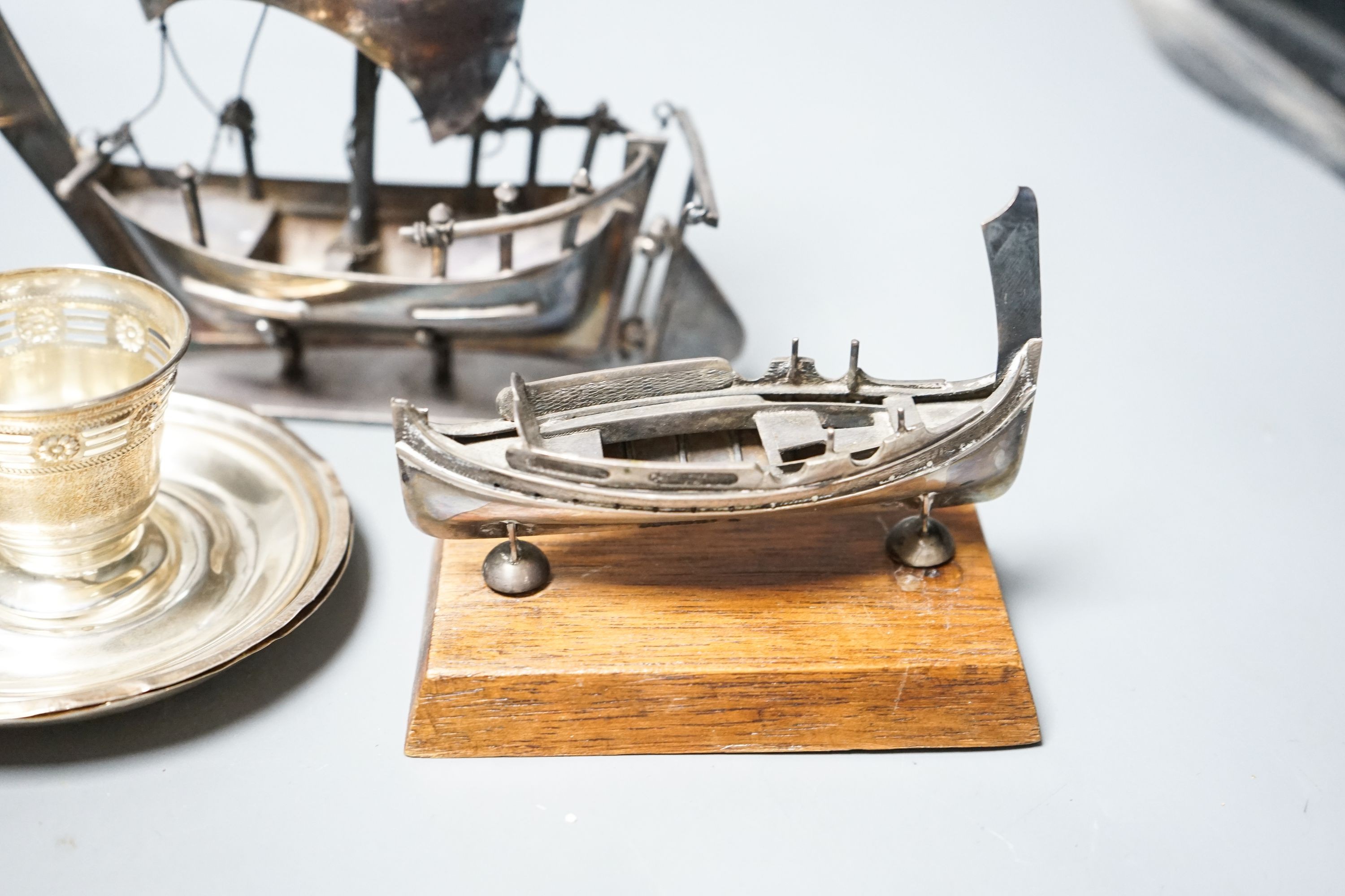 A silver butter shell and a pierced silver dish, two coin dishes and two boat models etc.